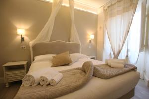 a bedroom with a bed with towels on it at Hotel Villa Margherita in Quercianella