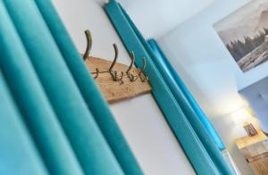 a antlers hanging on a wall next to blue curtains at Apartments Lakeside 29 Zell am See in Zell am See