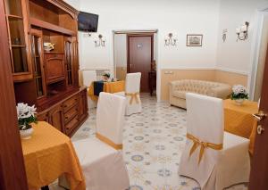 a living room with two tables and chairs in a room at Olimpo degli Dei in Naples