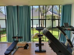 a gym with exercise equipment and a large window at Kingo Retreat Resort in Phú Quốc