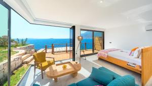 a bedroom with a bed and a view of the ocean at Mandalina Suites in Kaş