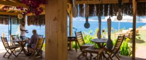 a group of people sitting at tables in a restaurant at Mandalina Suites in Kaş