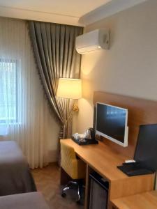 a hotel room with a desk with a computer on it at AK LİFE HOTEL&SUIT in Ankara
