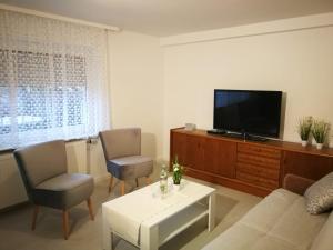 a living room with a couch and a tv at patrick's Ferienwohnung in Glauburg