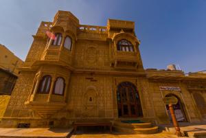 an old building in the middle of a street at Hotel Pleasant Haveli - Only Adults in Jaisalmer