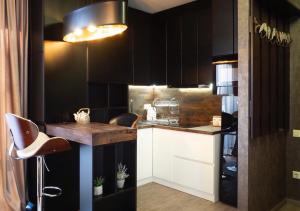 a kitchen with black and white cabinets and a counter at Bakuriani area park 57 in Bakuriani