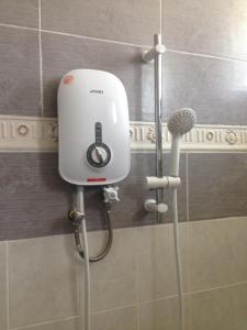 a hair dryer on the wall of a bathroom at holiday home bagan lalang 5 aircon in Kampong Bagan Lalang +31 photos