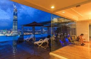 a woman sitting on the balcony of a building at D'majestic Place By Homes Asian 03 in Kuala Lumpur