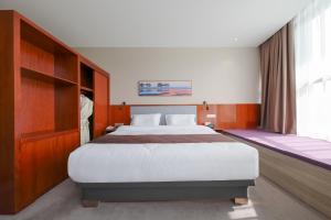 Postel nebo postele na pokoji v ubytování Shanghai Menglong Hotel Management