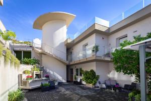 an exterior view of a house with a balcony at Zeus Hotel - Aparthotel - Meeting & Congress in Catania