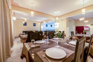 a dining room with tables and chairs in a restaurant at Magellan's The Golden Bridge in Lachung