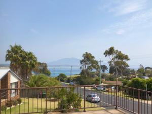 a view of the ocean from the balcony of a house at Bermagui Beach Apartment in Bermagui