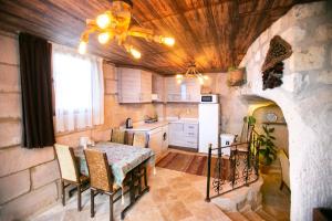 a kitchen with a table and a dining room at Kamelya Cave Hostel in Göreme