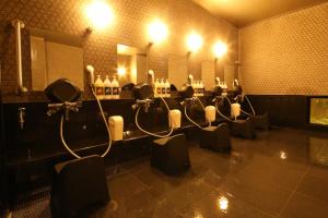 a bathroom with a row of sinks and mirrors at AB Hotel Yukuhashi in Yukuhashi