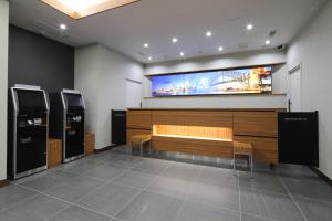 a waiting room with a tv on the wall at AB Hotel Yukuhashi in Yukuhashi