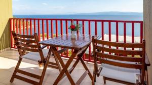 a table and two chairs on a balcony with the ocean at Skiathos Palace Hotel in Koukounaries