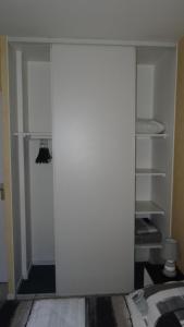 a white closet with a door in a room at Appart T2 standing tout confort au calme - parking en option in Lyon