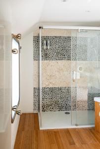 a shower with a glass door in a bathroom at Arcadia - Péniche de Standing à Namur avec vue sur la Citadelle in Namur