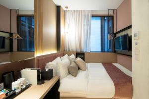 Postel nebo postele na pokoji v ubytování Hotel NuVe Elements