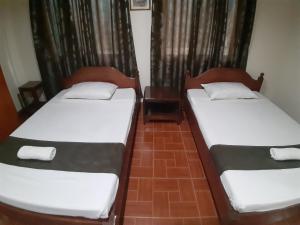 Ein Bett oder Betten in einem Zimmer der Unterkunft Raq Pensionne House