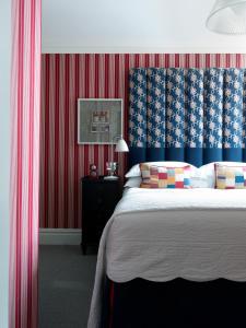 a bedroom with a bed, a desk, and a lamp at Dorset Square Hotel, Firmdale Hotels in London