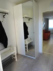a dressing room with a mirror and a red couch at 203 Rom, Studio Apartment, 38m2 1-4 Pers in Klagenfurt