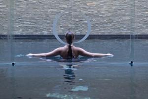 a woman in the water with a hula hoop at Posia Retreat & Spa UNA Esperienze in San Foca