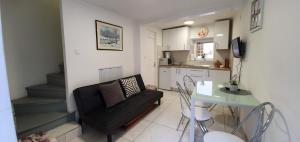 salon z czarną kanapą i stołem w obiekcie Guest House Novalja w Novalji
