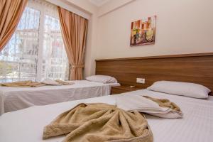 Postel nebo postele na pokoji v ubytování Körfez Garden Apartments