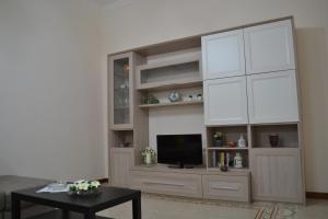 a living room with a large entertainment center with a television at GARDENIA in Salerno