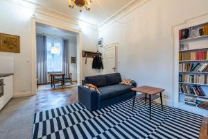 a living room with a blue couch and a table at Victus Apartamenty Apartament Bolek i Lolek in Sopot