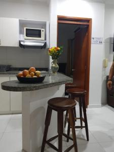 a kitchen with a counter with a bowl of fruit on it at Apartamentos Playa Rodadero in Santa Marta