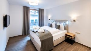 Łóżko lub łóżka w pokoju w obiekcie MANNI home - rooms & apartments