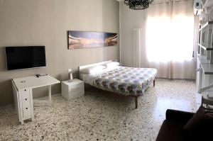 ナポリにあるLa Dimora dell'Avvocatoのベッドルーム(ベッド1台、テレビ、テーブル付)