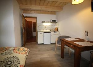 a kitchen and dining room with a table and a table and chairs at Apartmány u Knajflů in Petrovice