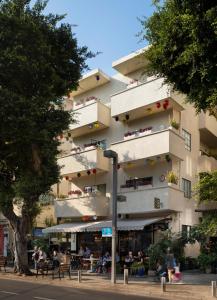 
a large building with a lot of trees at Cucu Hotel By 7Minds in Tel Aviv
