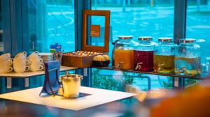 a display case with jars of different colored liquids at Hotel Blue in Zagreb