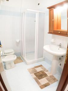 a bathroom with a shower and a toilet and a sink at Welcome Traveller IL BORGO APARTMENT in Bardolino +7 photos