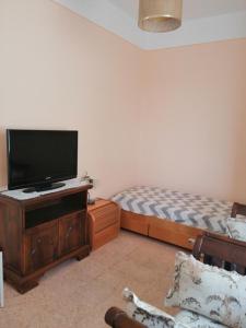 a bedroom with a bed and a flat screen tv at Appartamento Beatrice in Pistoia