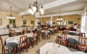 a restaurant with tables and chairs in a room at Hotel Pironi in San Mauro a Mare
