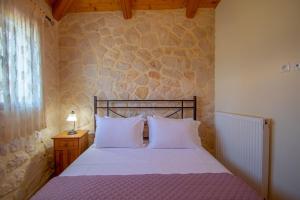 Postel nebo postele na pokoji v ubytování Kantouni House