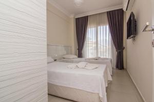 Postel nebo postele na pokoji v ubytování Körfez Garden Apartments