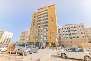 a group of cars parked in front of a building at Alpha Suites Hotel in Salalah