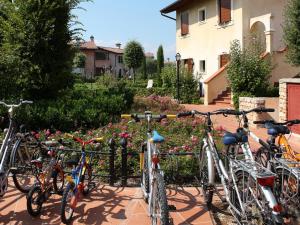 a group of bikes parked next to a fence at Well-kept apartment with view of the swimming pool in Peschiera del Garda