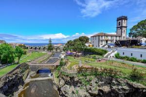 a view of a town with a clock tower at Hotel Verde Mar & SPA in Ribeira Grande