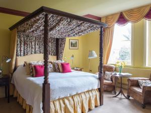 A bed or beds in a room at Gliffaes Country House Hotel 