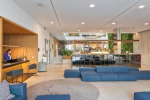 a lobby with blue couches and a bar at Posia Retreat & Spa UNA Esperienze in San Foca