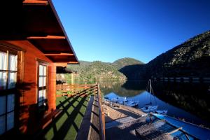 a cabin with a view of a lake and mountains at Douro Yacht Charter & Bungalows in São João da Pesqueira