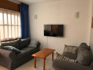 a living room with a couch and a table at Garrucha in Garrucha