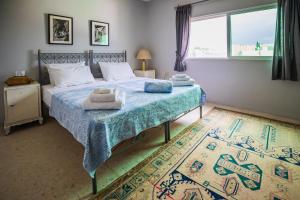 a bedroom with a bed with towels on it at Beit Al Baraka in Um Qeis +40 photos